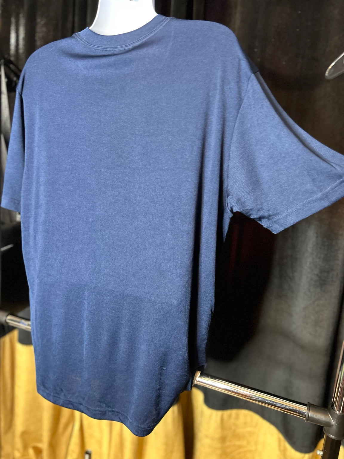 Close-up of navy knit texture and hem crest tab