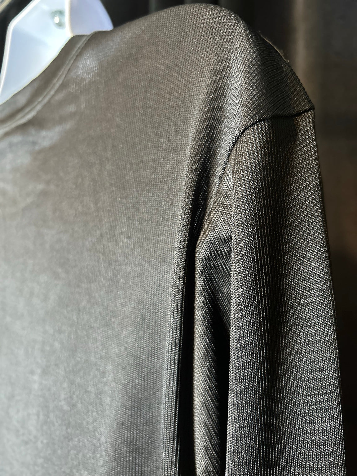 Close-up of black knit fabric and sleeve